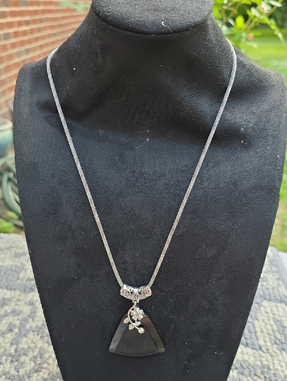 Silver and Black Pendant Necklace with Floral Accent